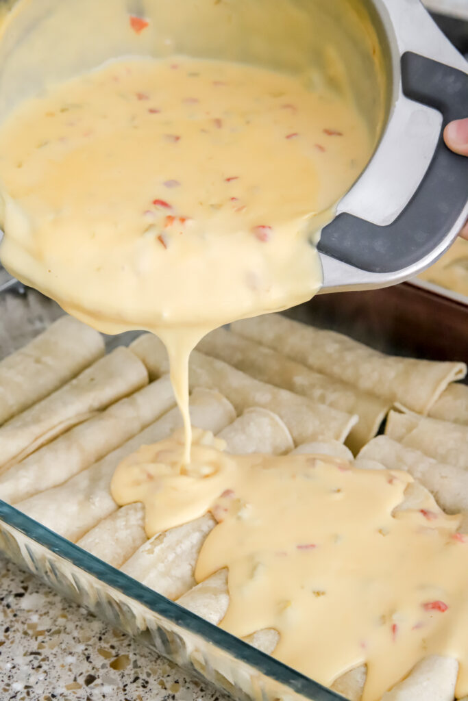 Creamy cheese sauce over beef enchiladas