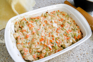 add chicken and vegetables into a 9x13 pan for chicken pot pie.