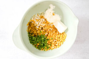add corn, green chilies and cream cheese in a bowl for hot corn dip