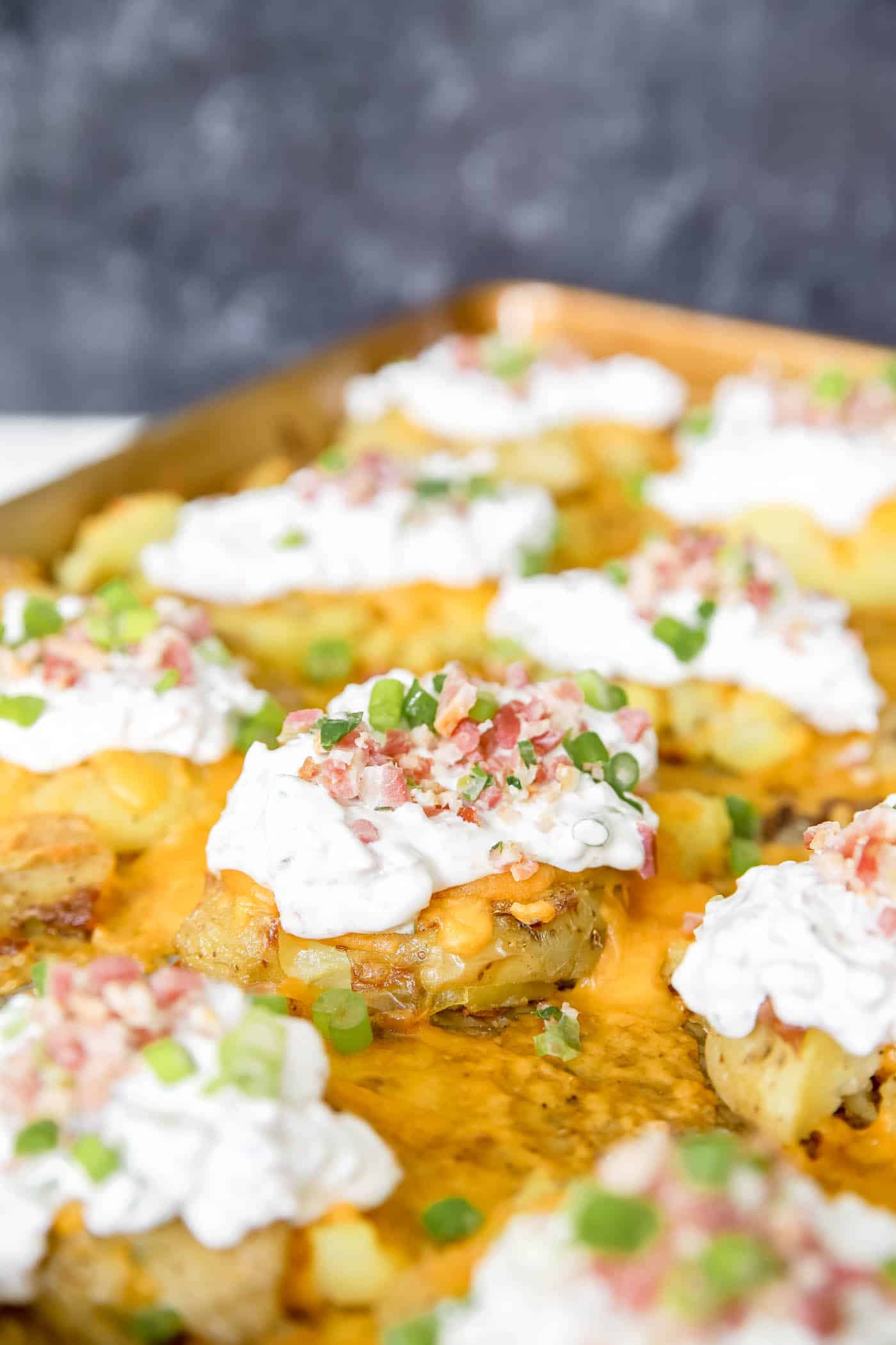 Loaded smashed potatoes side dish.