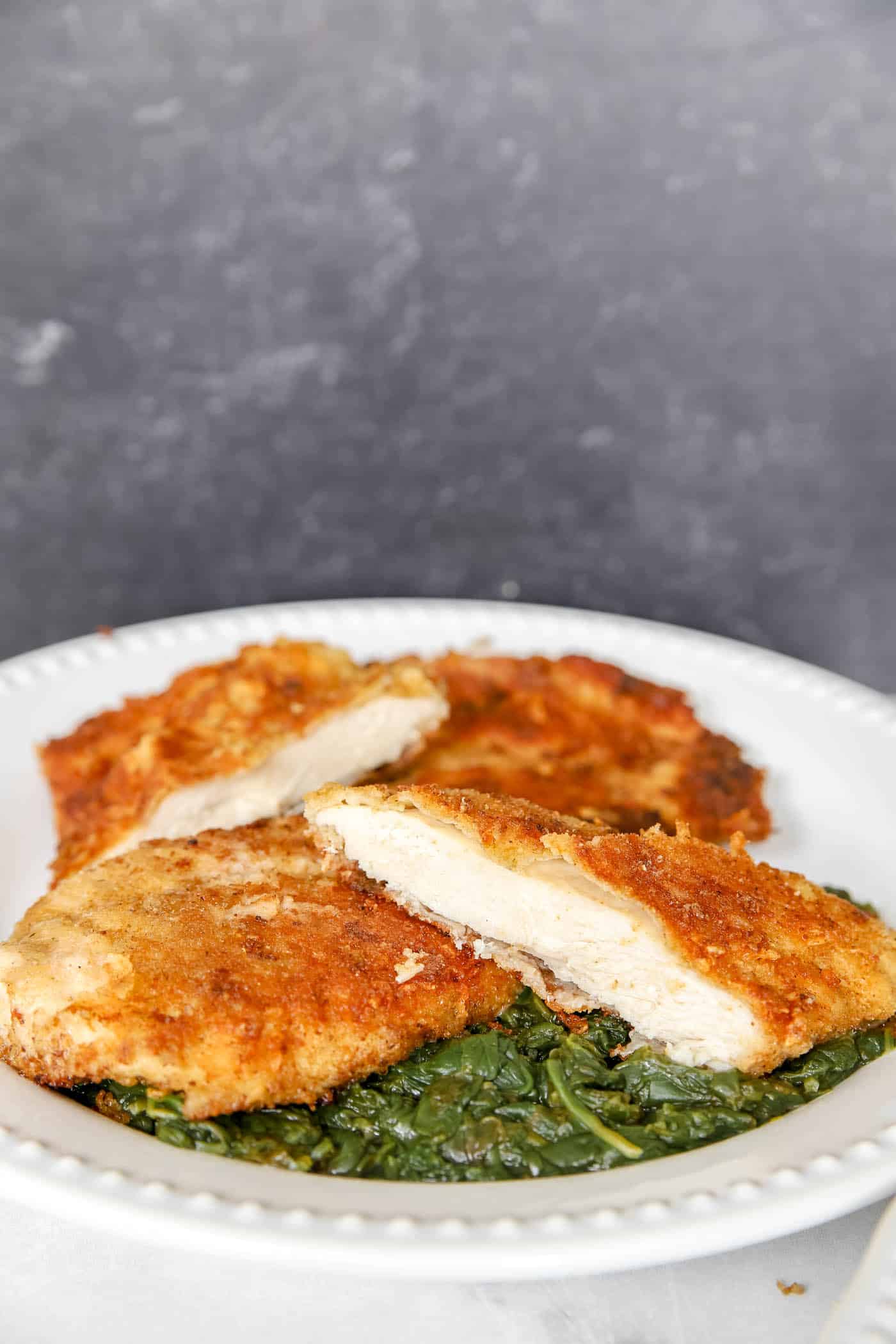 Paermesan Chicken Recipe on bed of spinach