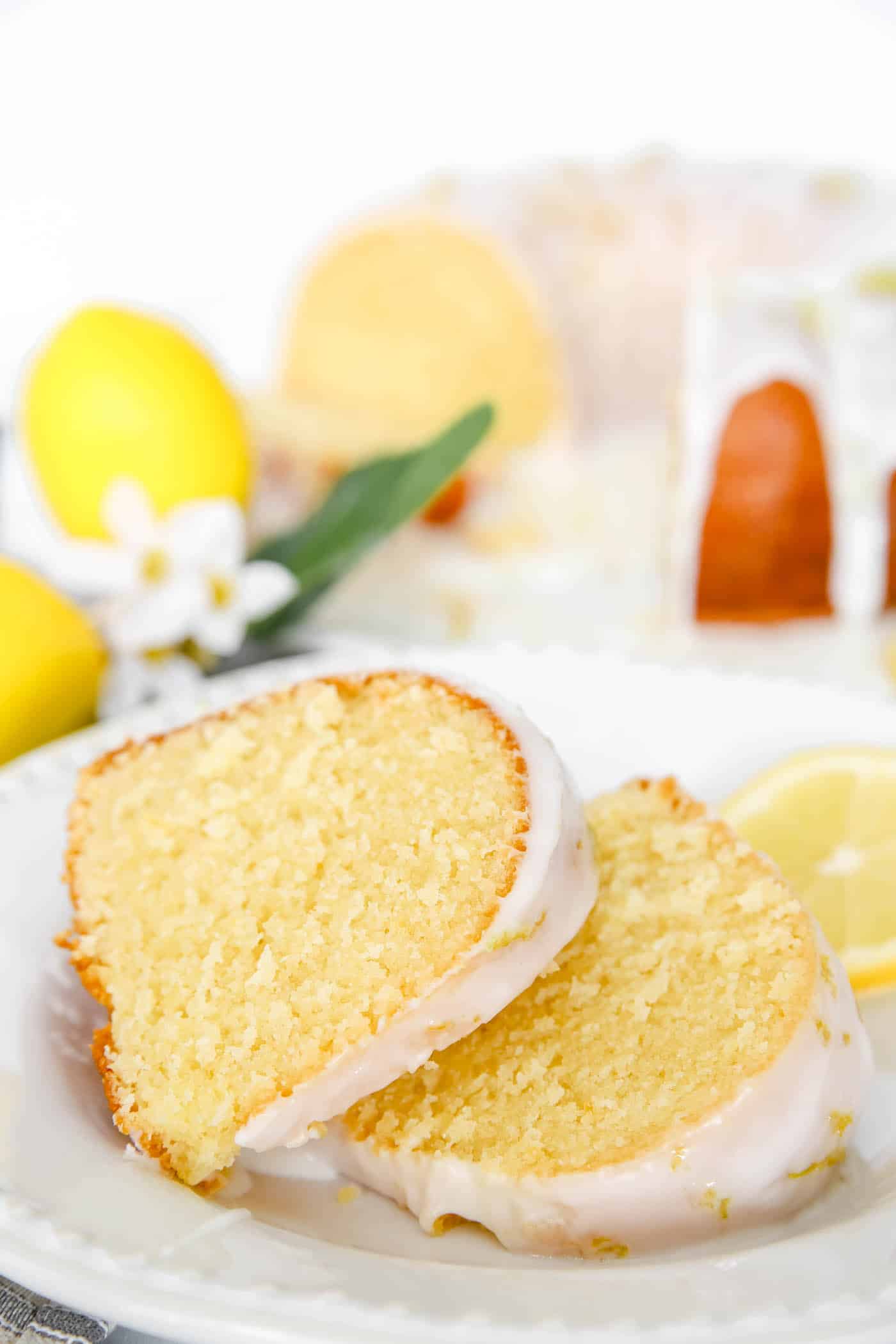 lemon Bundt cake slices with cake in the background.
