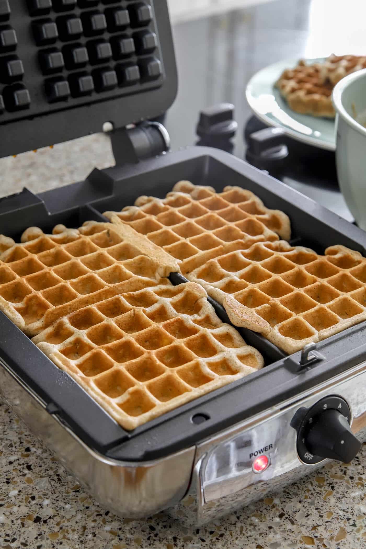 apple waffles on a waffle maker.