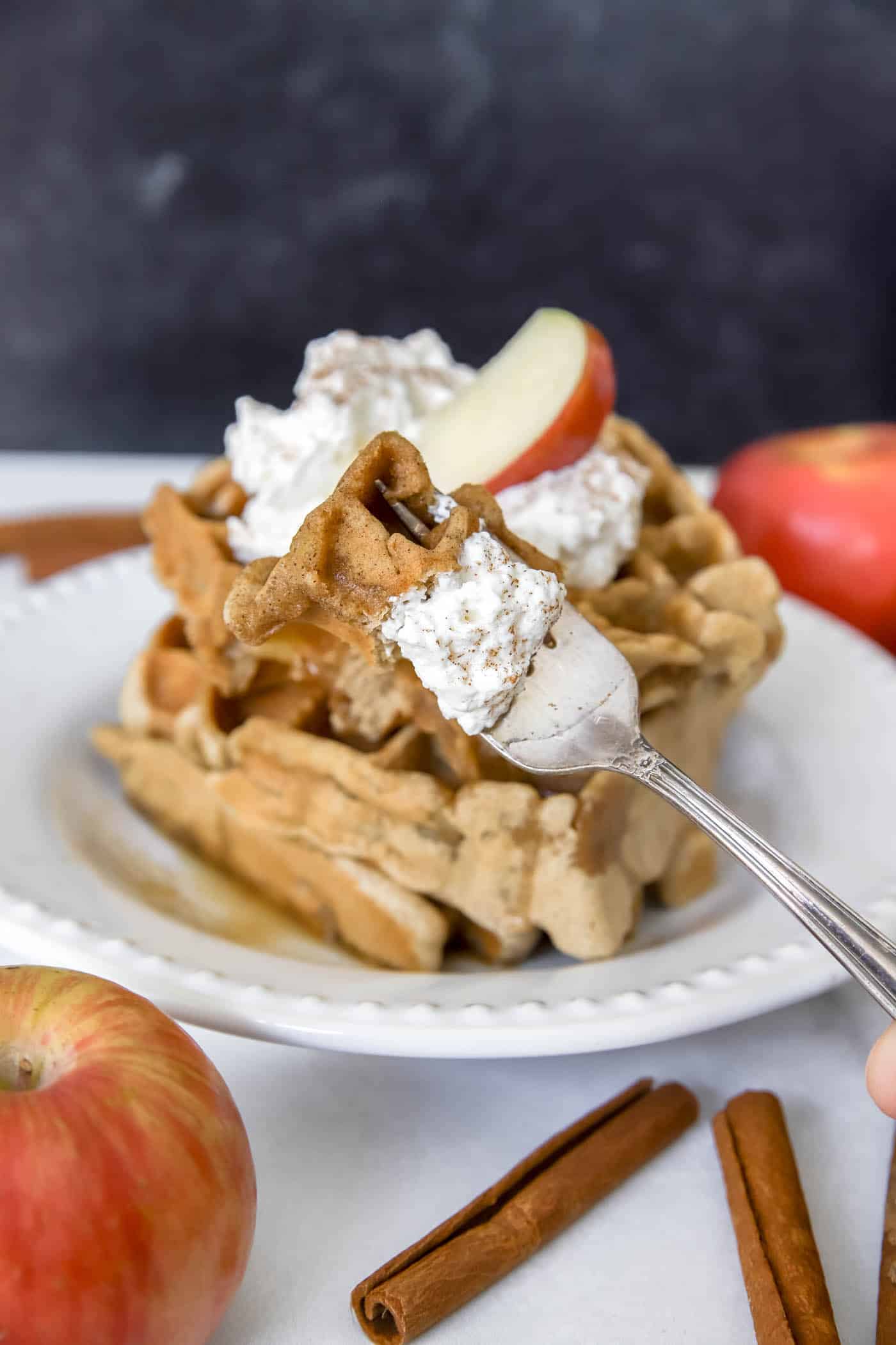 apple waffles with cinnamon and whipped cream topping.