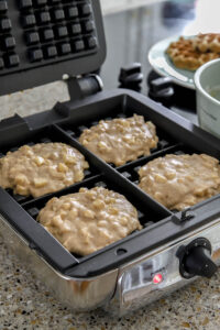 apple cinnamon waffle batter in waffle iron.