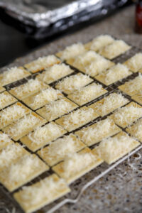 add parmesan cheese to club crackers for bacon cracker appetizers