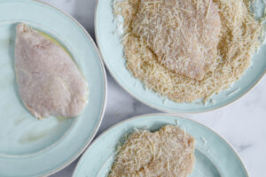 press the bread crumb and paremsan mixture on parmesan chicken