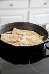 brown chicken in a cast iron skillet