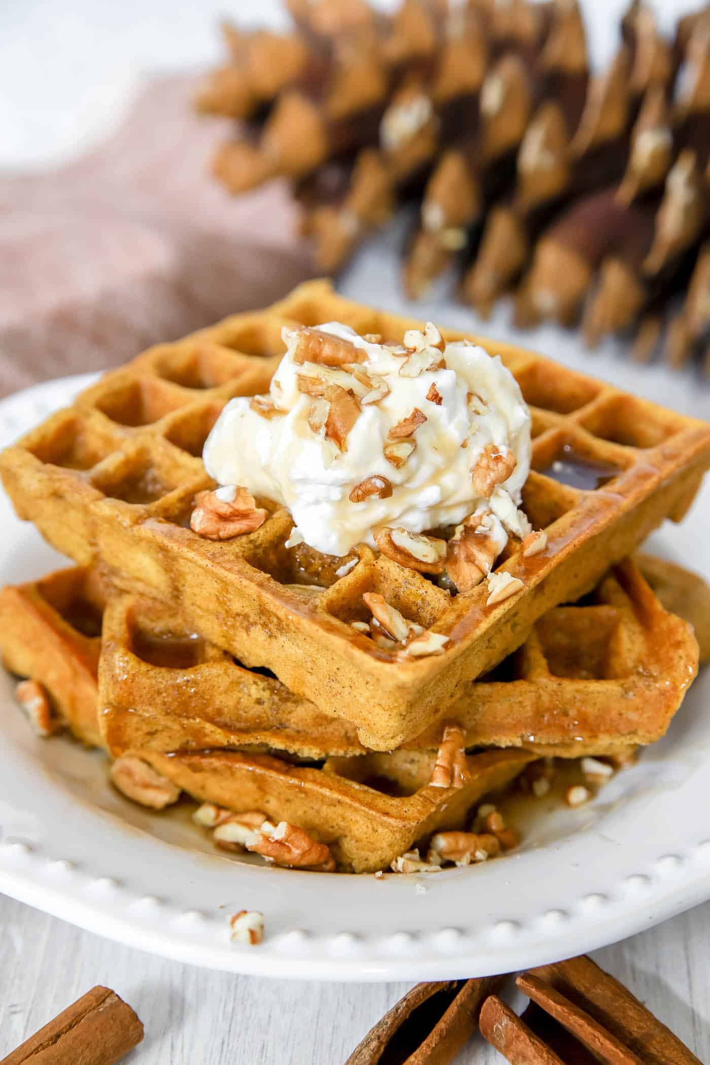 pumpkin waffles with whipped cream and pecans