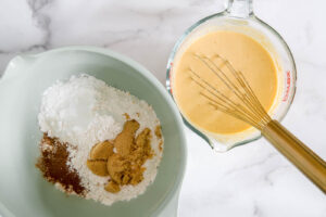 ingredients for pumpkin waffles mixing together.