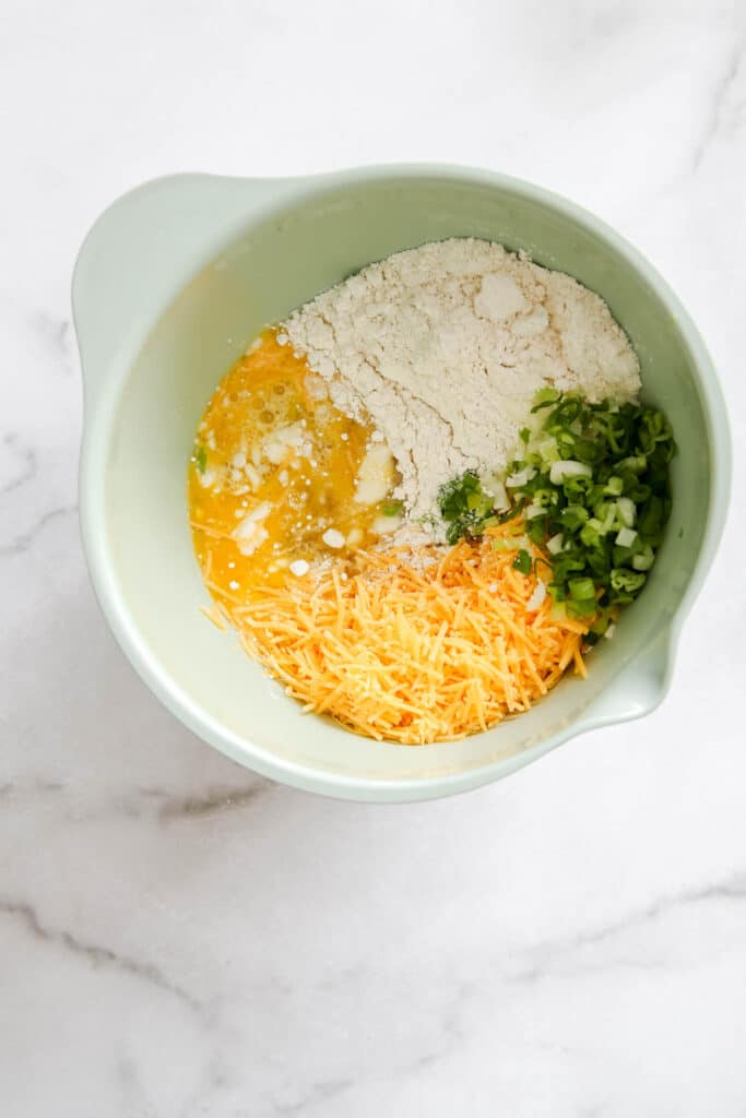 ingredients in a bowl for easy sausage muffins