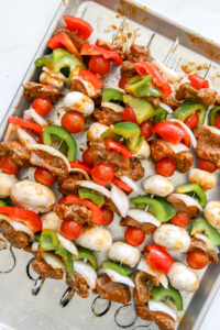 meat and vegetables on skewers for grilled beef kabobs.