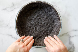 oreo crumbs pressed into a pie plate for mint chocolate chip pie