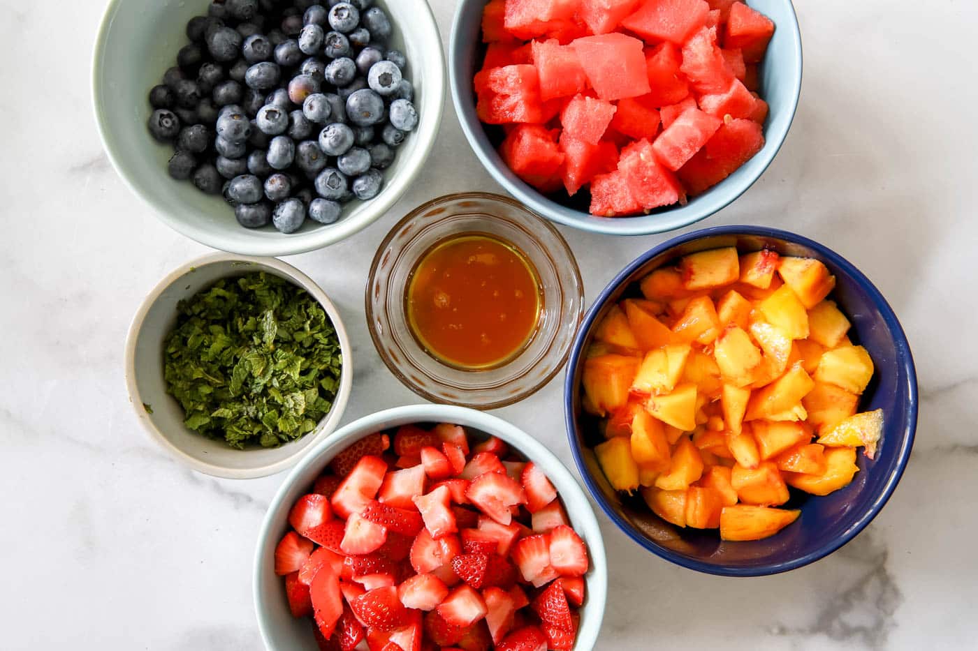 chopped fruit for summer fruit salad with mint and honey.