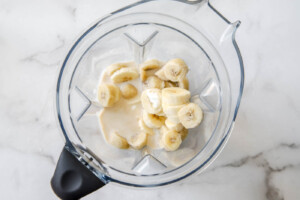creamy banana smoothie ingredients in blender.