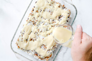 sweetened condensed milk on top of hello dolly bars.