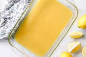 lemon curd in the bottom of a baking dish for lemon dump cake.