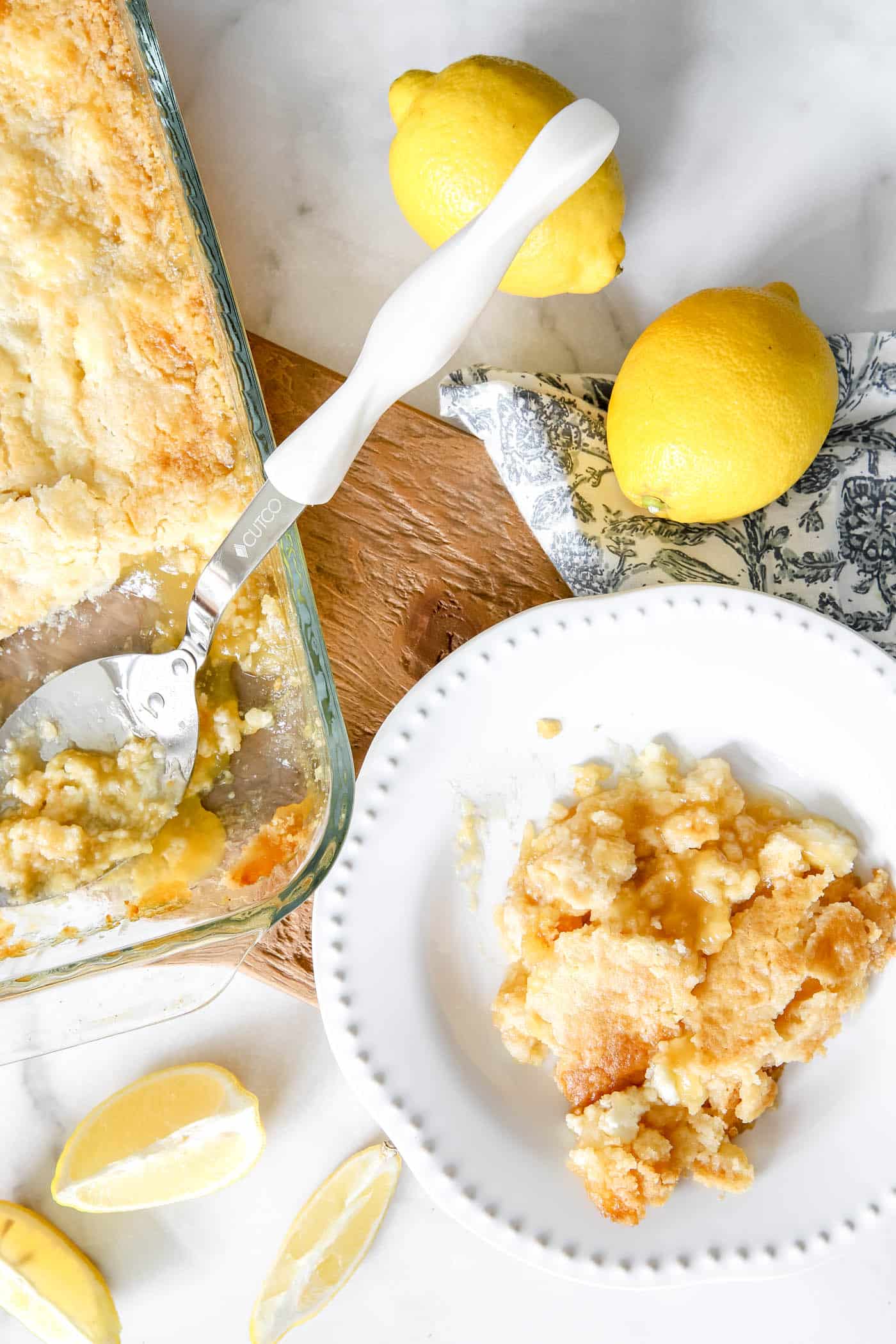 lemon dump cake scooped out on a plate.