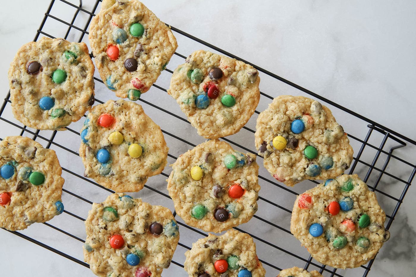 chewy monster cookies on a cooling rack.