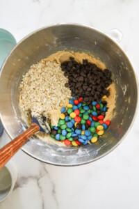add dry ingredients to stand mixer for monster cookie recipe.