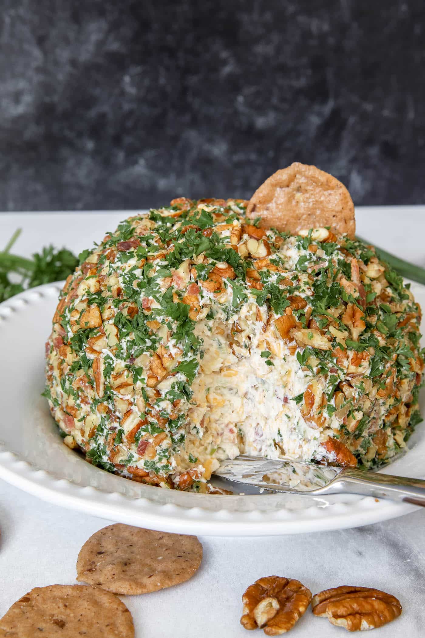 cheese ball with pineapple and bacon on a cracker.