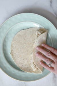 roll tortilla with chicken mixture for white chicken enchiladas