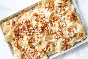 onions on top of bbq chicken sheet pan nachos.