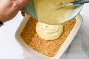 key lime pie bars filling on top of graham cracker crust.