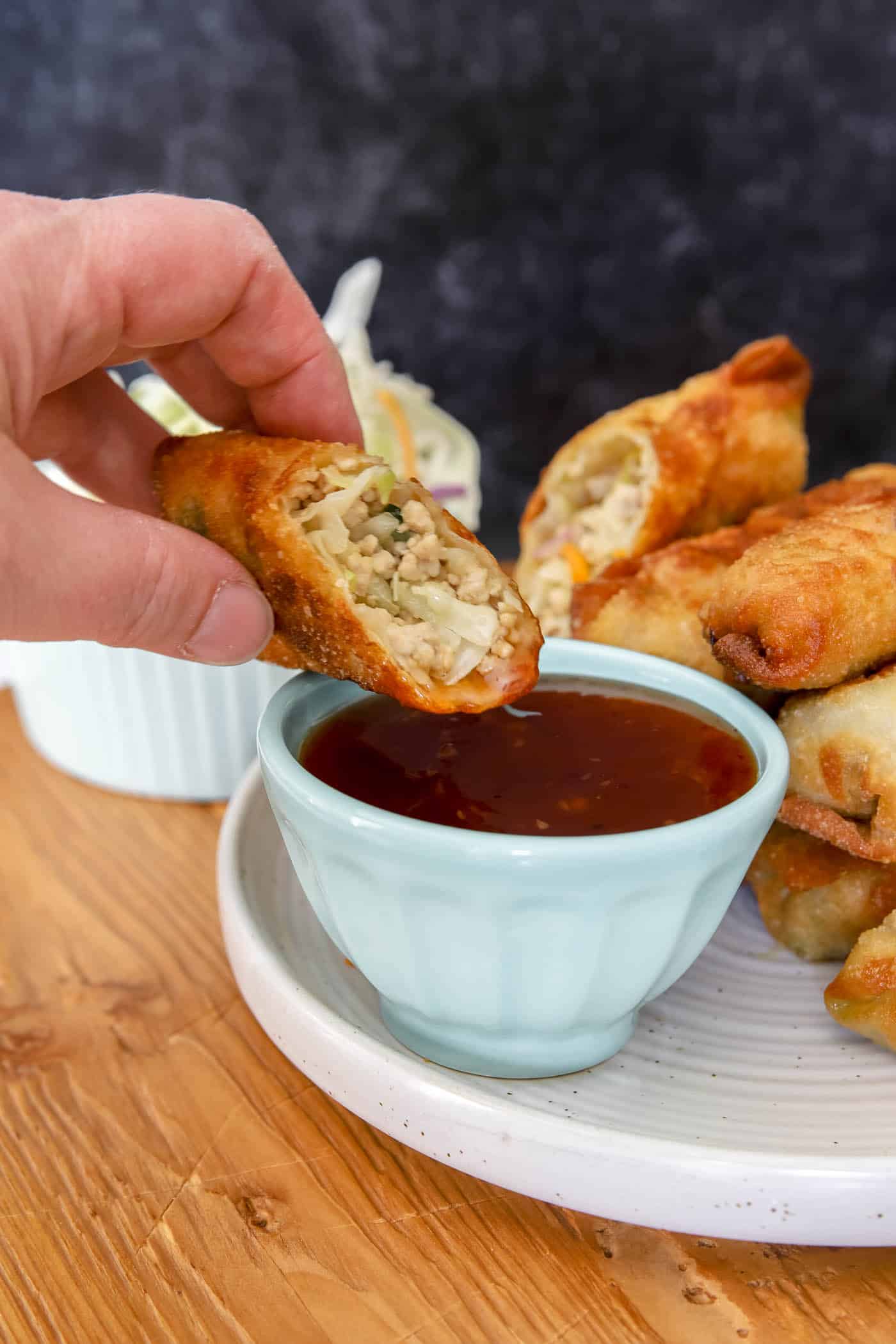 homemade egg rolls dipped in Thai chili sauce.