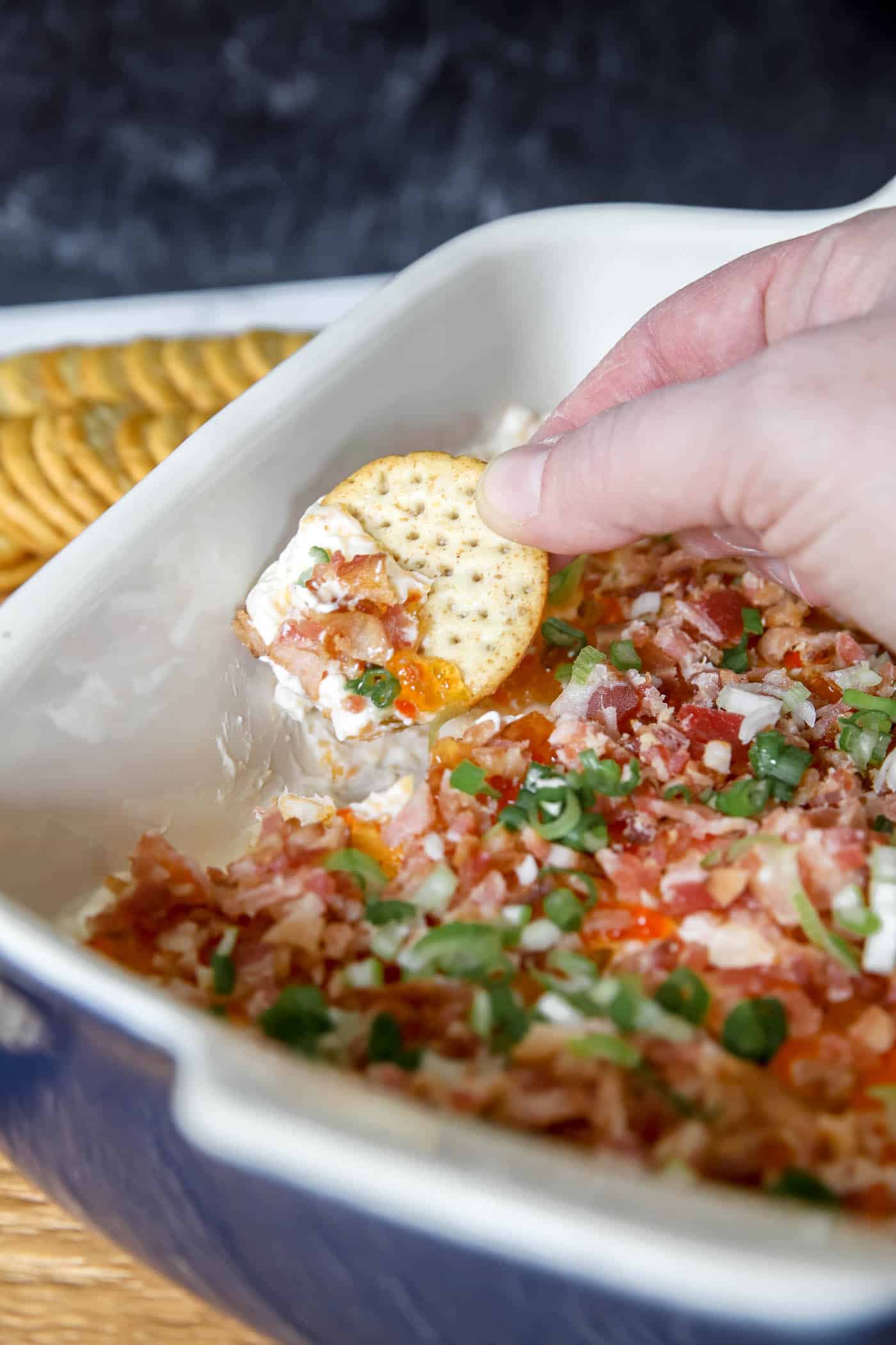 pepper jelly cream cheese dip in a serving dish.